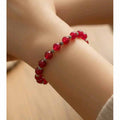 Faceted red jade (8mm) with silver coloured spacers